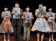 几个SPU学生演员穿着戏服，拿着报纸，戴着白色面具